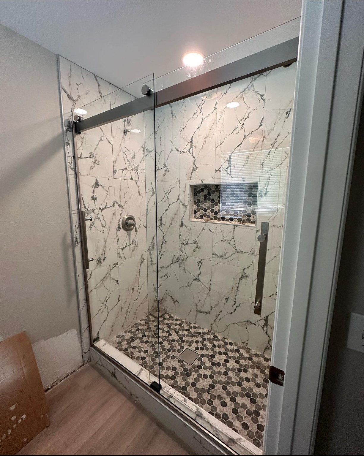 Finished tiled shower with sliding glass enclosure