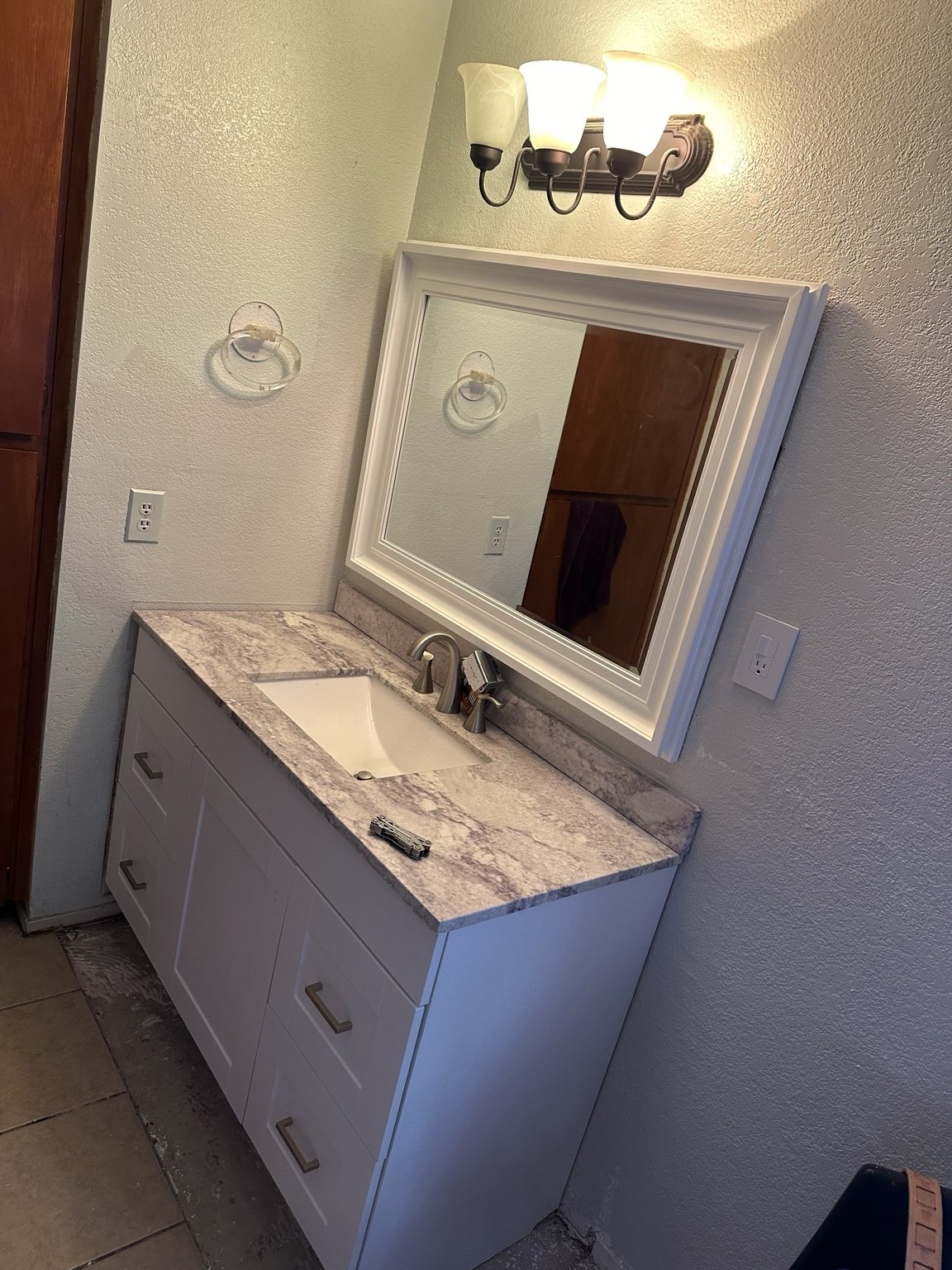 Finished white bathroom vanity and mirror